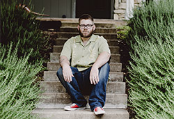 James sits on his front steps