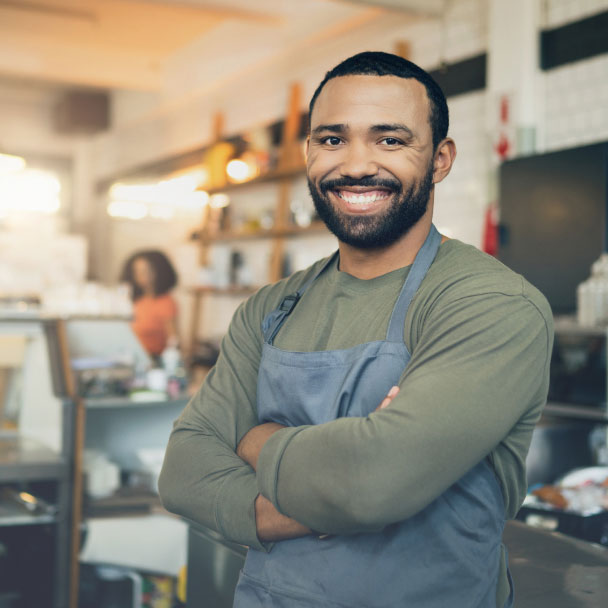 Smiling man behind the counter in a cafe.