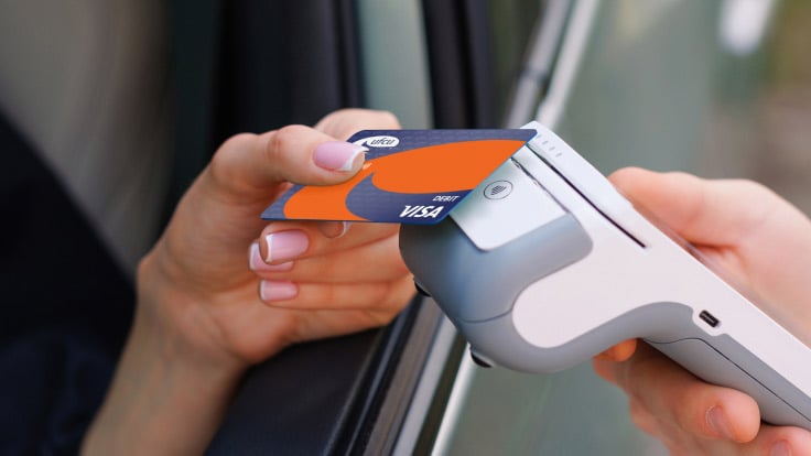 Debit card being scanned by a card reader.