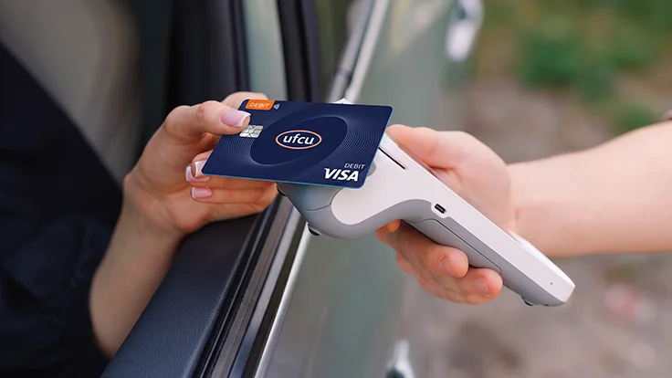 Debit card being scanned by a card reader.