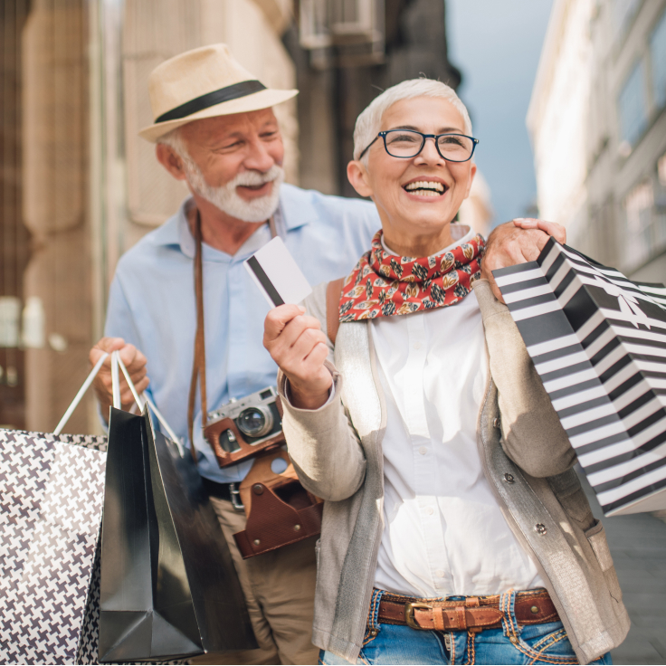 Happy couple with many shopping bags.