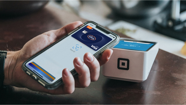 Person using their mobile phone to pay make a payment.